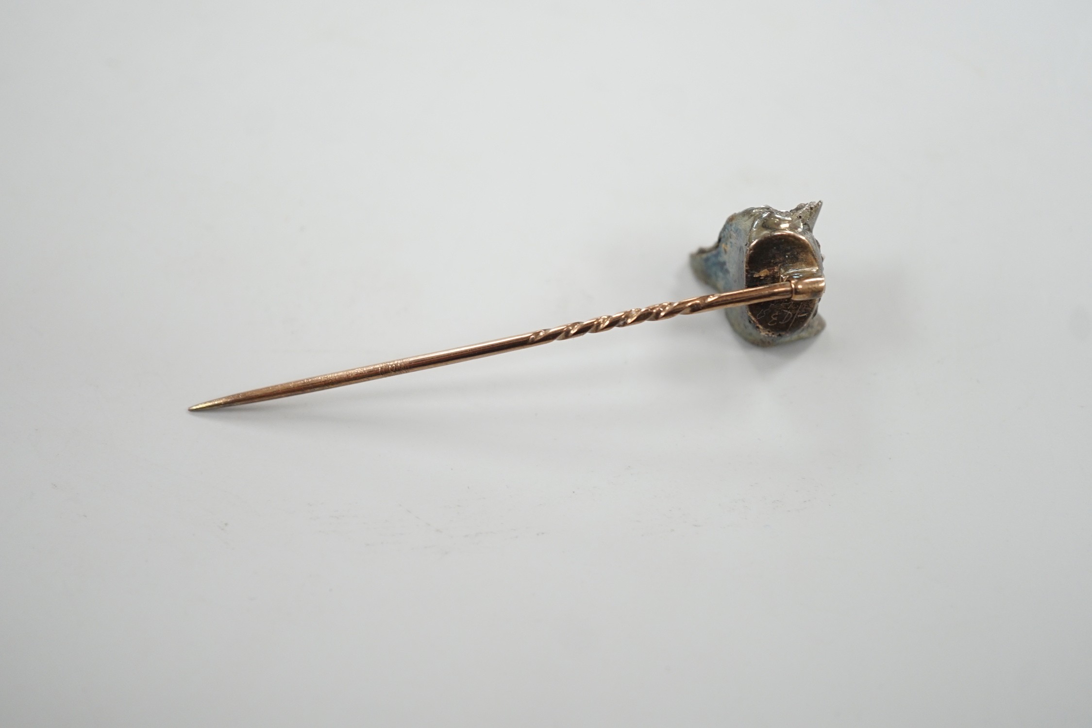 A late Victorian yellow and white metal, cabochon ruby? and rose cut diamond set fox head stick pin, 56mm, gross weight 4.7 grams (two stones missing).